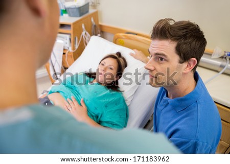 http://thumb9.shutterstock.com/display_pic_with_logo/102/171183962/stock-photo-high-angle-view-of-mid-adult-man-and-pregnant-woman-listening-to-nurse-in-hospital-room-171183962.jpg