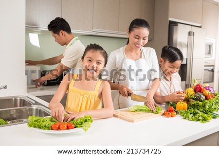Happy Vietnamese family cooking dinner together