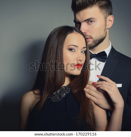 http://thumb9.shutterstock.com/display_pic_with_logo/111616/170229116/stock-photo-portrait-of-beautiful-young-man-and-woman-dressed-in-classic-clothes-studio-shot-over-grey-170229116.jpg