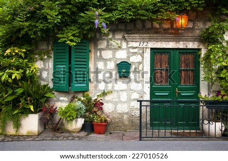 welcoming facade. a small structure in Montenegro. a lot of flowers in 