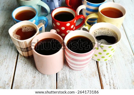 stock-photo-many-cups-of-coffee-on-wooden-table-closeup-264173186.jpg