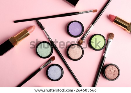 Set of decorative cosmetics on light colorful background - stock photo