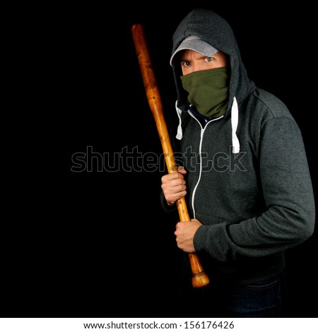 Male thug in hoodie waiting to attack with wooden baseball bat ...