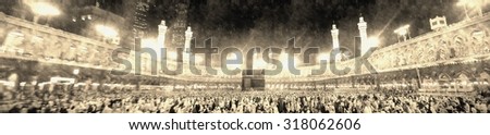 Muslim pilgrims circumambulate the Kaaba after dawn prayer at Masjidil Haram in Makkah, Saudi Arabia in vintage style.Muslims all around the world face the Kaaba during prayer time. - stock photo