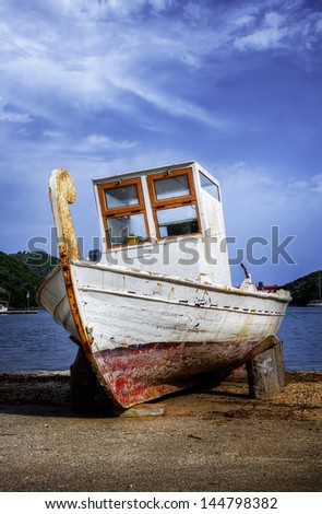 small fishing boat out of the water, for repairs, in Syvota village 