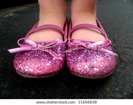 little girl is wearing pink, sparkly tap shoes. Horizontally framed