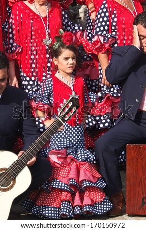 stock-photo-nerja-spain-october-a-little-girl-wearing-a-traditional-andalusian-red-dress-is-standing-170150972.jpg