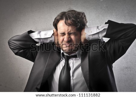 stock-photo-annoyed-businessman-covering-his-ears-with-his-hands-111131882.jpg