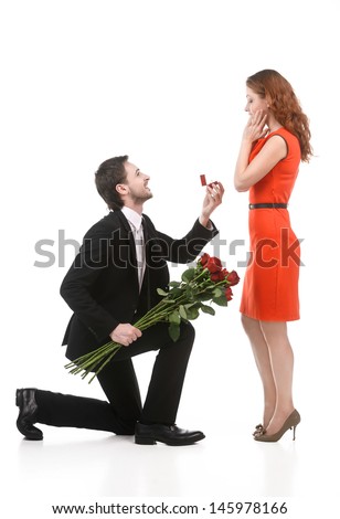 stock-photo-young-man-in-full-suit-standing-on-one-knee-and-making-a-proposal-to-his-girlfriend-against-white-145978166.jpg