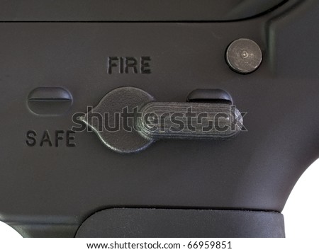 stock-photo-safety-selected-on-the-fire-control-switch-on-an-assault-rifle-66959851.jpg