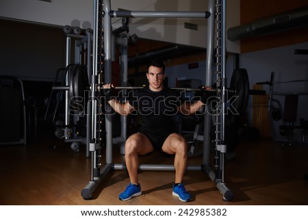 stock-photo-young-professional-bodybuilder-working-out-doing-squats-with-barbell-242985382.jpg