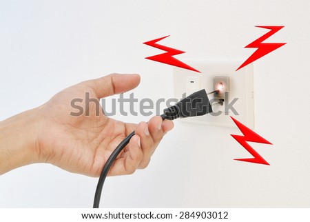 Hand and Plug Electricity shock - stock photo