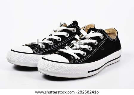 Black canvas shoes on a white background - stock photo