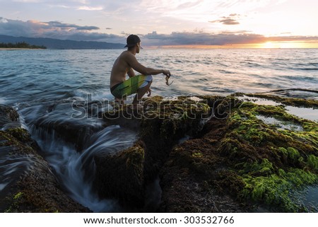 tide pool covered water seaweed kneeling reef shore rocks holding glasses line man ocean shutterstock swells flowing