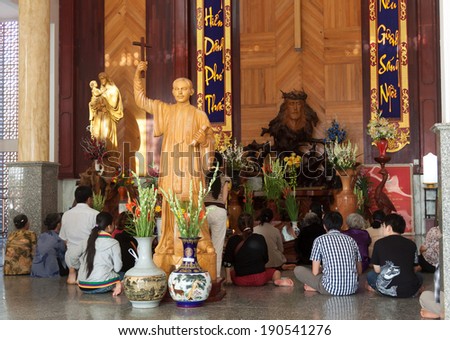  - stock-photo-bac-lieu-vietnam-march-the-faithful-sitting-around-buu-diep-priest-statue-at-tac-say-church-190541276