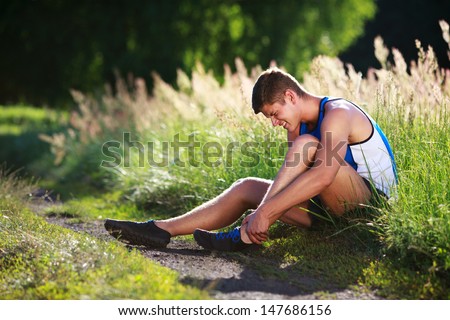 stock-photo-twisted-ankle-young-runner-touching-his-sprained-leg-147686156.jpg