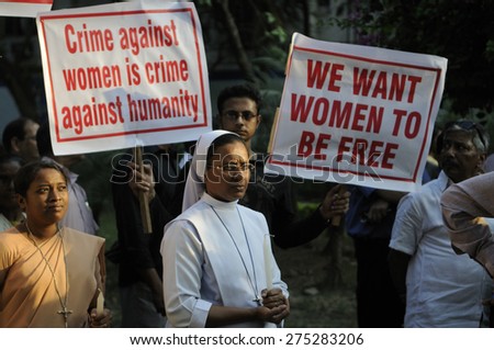 KOLKATA - MARCH 16 : A Christian Nun standing in prayer during a candle light vigil to protest gang rape of an elderly nun near Ranaghat on March 16, 2015 at Allen Park in Kolkata, India. - stock photo