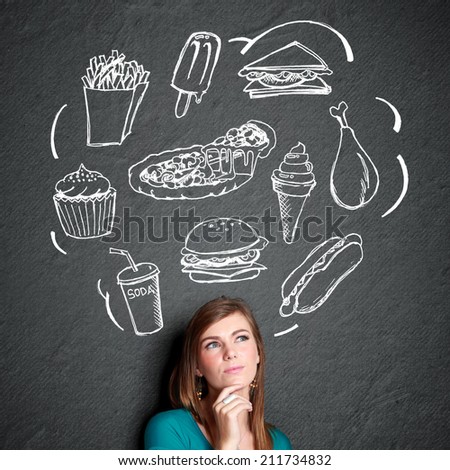 portrait of confuse young woman looking up thinking what to eat. fast ...