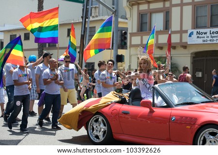 stock-photo-long-beach-may-activists-holding-flags-behind-a-car-with-a-beauty-queen-during-the-long-beach-103392626.jpg