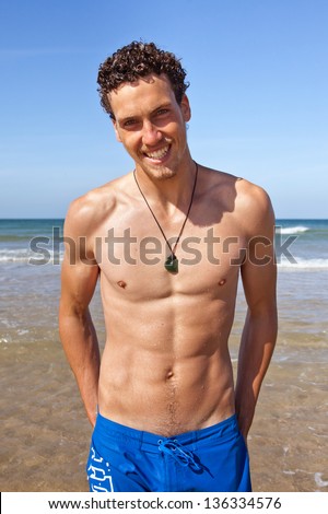 Young handsome muscular man in a bathing suit hanging on the beach ... Young handsome muscular man in a bathing suit hanging on the beach ...