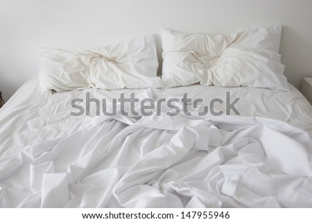 View of an unmade bed - stock photo