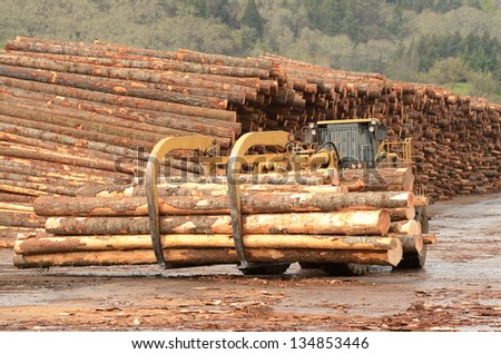 stock-photo--large-wheeled-front-end-log-loader-working-the-log-yard-at-a-lumber-processing-mill-that-134853446.jpg