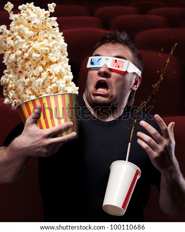 stock-photo-portrait-of-very-scared-man-watching-d-movie-drinking-cola-and-eating-popcorn-100110686.jpg