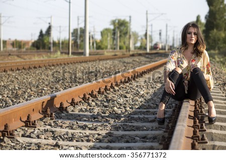 Woman Traveler With Cell Waiting For Train On Platform 