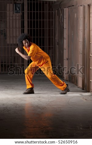 stock-photo-a-young-african-american-man-with-an-afro-is-looking-behind-him-as-he-is-making-an-escape-from-a-52650916.jpg