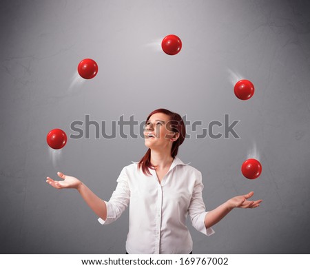 pretty young girl standing and juggling with red balls - stock photo