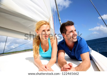 stock photo smiling couple relaxing on a yacht by sunny day 122465662