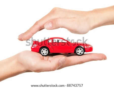 Red car in hands on a white background. Concept of safe driving Red car in hands on a white background. Concept of safe driving