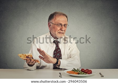 stock-photo-say-no-to-fast-food-senior-man-eating-fresh-vegetable-salad-avoiding-fatty-pizza-296043506.jpg