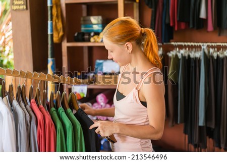 Pretty Woman Trying On Blue Dress At Clothes Store Stock Photo