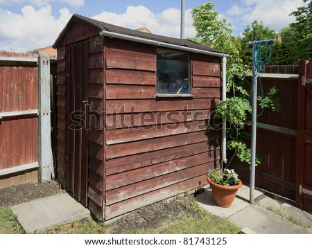 garden wooden shed with planks in a yard. - stock photo