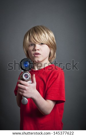 stock-photo-boy-pointing-toy-laser-gun-145377622.jpg