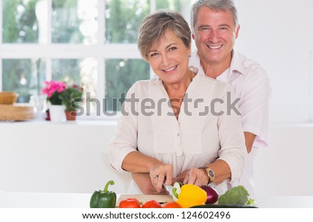 http://thumb9.shutterstock.com/display_pic_with_logo/76219/124602496/stock-photo-smiling-woman-cutting-vegetables-with-her-husband-hugging-her-from-behind-in-kitchen-124602496.jpg