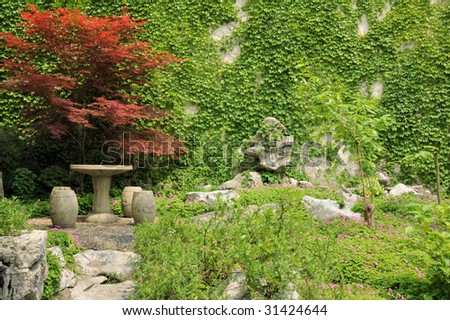 stock-photo-chinese-old-style-stone-circular-table-and-chairs-in-a-garden-in-china-31424644.jpg