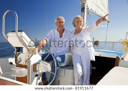 stock photo a happy senior couple sitting at the wheel of a sail boat on a calm blue sea 81911677