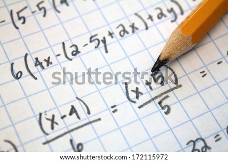 math problems on graph paper with pencil - stock photo
