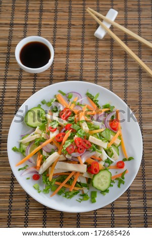 Squid salad with carrot, onion, cucumbers, chili peppers, and soy ...