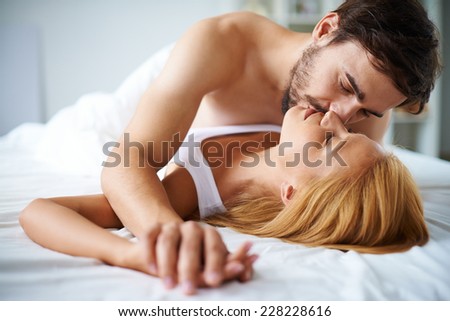 stock-photo-amorous-couple-cuddling-in-bed-228228616.jpg