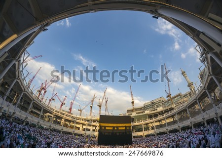 MECCA, SAUDI ARABIA-CIRCA DEC 2014: WIde angle view of Muslim pilgrims circumambulate the Kaaba counter-clockwise at Masjidil Haram in Makkah, Saudi Arabia. - stock photo