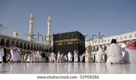 MAKKAH - APRIL 23 : A close up view of pilgrims circumambulate the Kaaba at Masjidil Haram on April 23, 2010 in Makkah, Saudi Arabia. Muslims all around the world face the Kaaba during prayer time. - stock photo