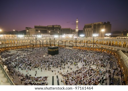 Muslim pilgrims circumambulate the Kaaba after dawn prayer at Masjidil Haram in Makkah, Saudi Arabia. Muslims all around the world face the Kaaba during prayer time. - stock photo