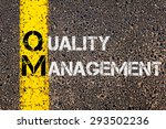 Small photo of Concept image of Business Acronym QM as Quality Management written over road marking yellow painted line.