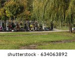 stock-photo-cemetery-in-central-europe-many-tombstones-decorated-with-candles-flowers-and-other-such-items-634063892.jpg