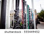 Small photo of mardi gras beads on a fence in the french quarter of New Orleans