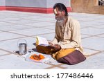 Small photo of Gangotri, Uttarakhand - CIRCA May 2013 - A Hindu priest sits in the temple courtyard to read Vedic scriptures in Gangotri circa May 2013.