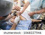 Small photo of Surgical Procedure. Anesthesiologist performing an orotracheal intubation in a patient to control of the airway. General Anesthesia.